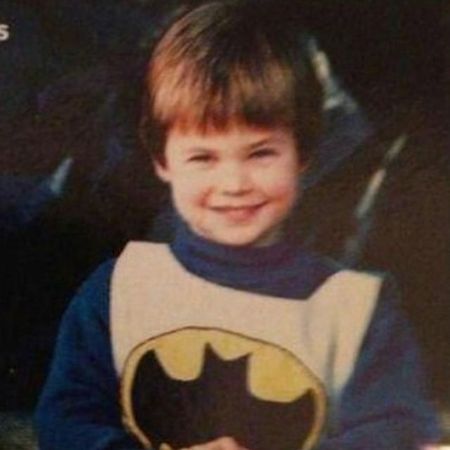 Young Chris Hemsworth wearing a batman shirt posing for a picture